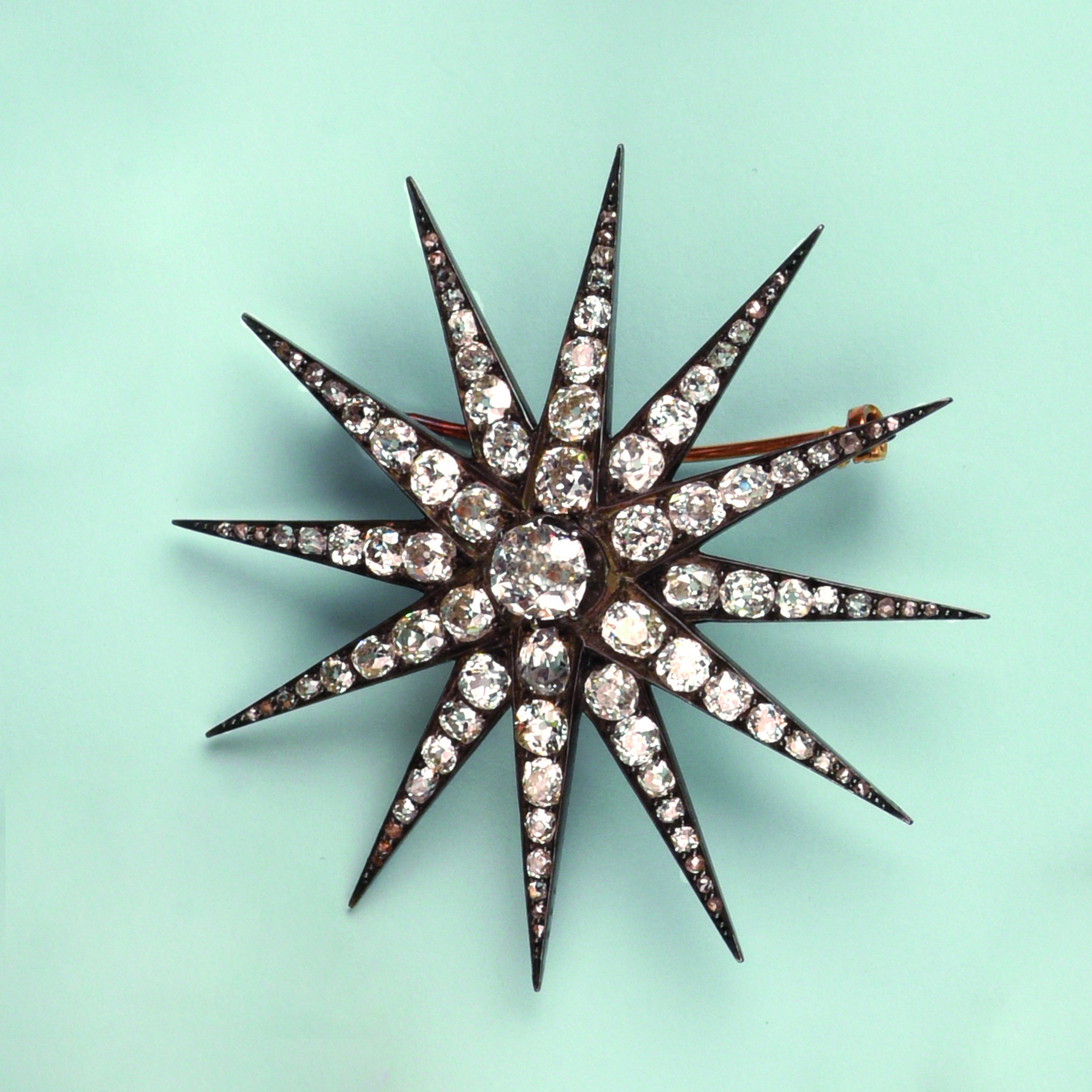 Broche « étoile » en argent et or rose 750, entièrement pavée de diamants de taille ancienne dans un décor rayonnant, travail français du 19ème siècle - H. env. 6,5cm, poids brut env. 17,0 g.